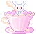 A pink scalloped teacup with tiny white bunny peeking out